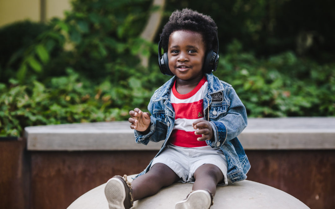 Top Ten Podcast Episodes 2018: Little boy listening to headphones